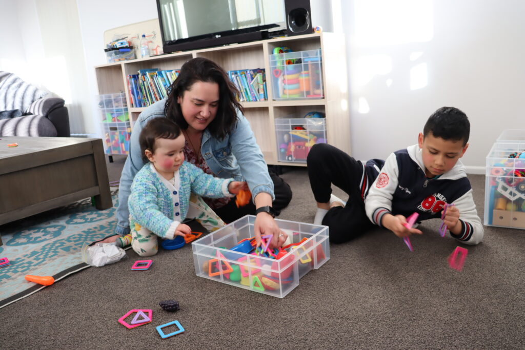 Leah, Mary Potter Hospice volunteer, and her two children playing at home